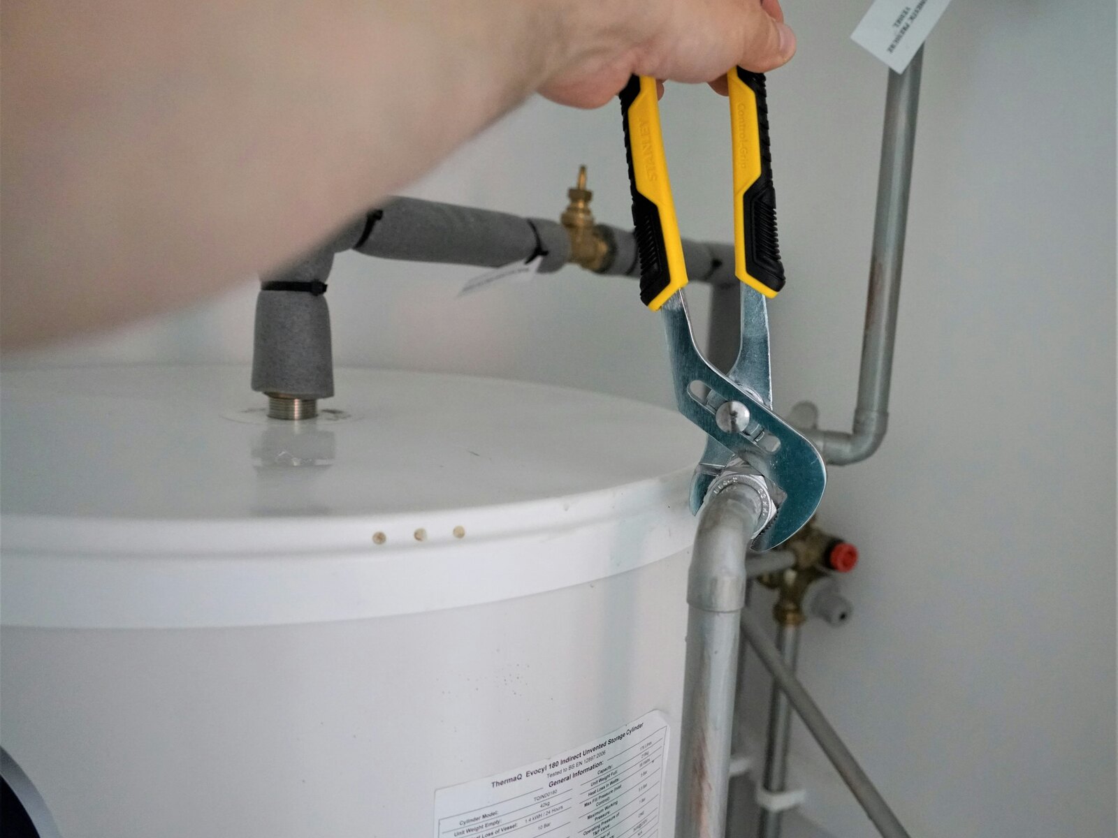 A Swift Plumb Tulsa plumber at work on a pipe